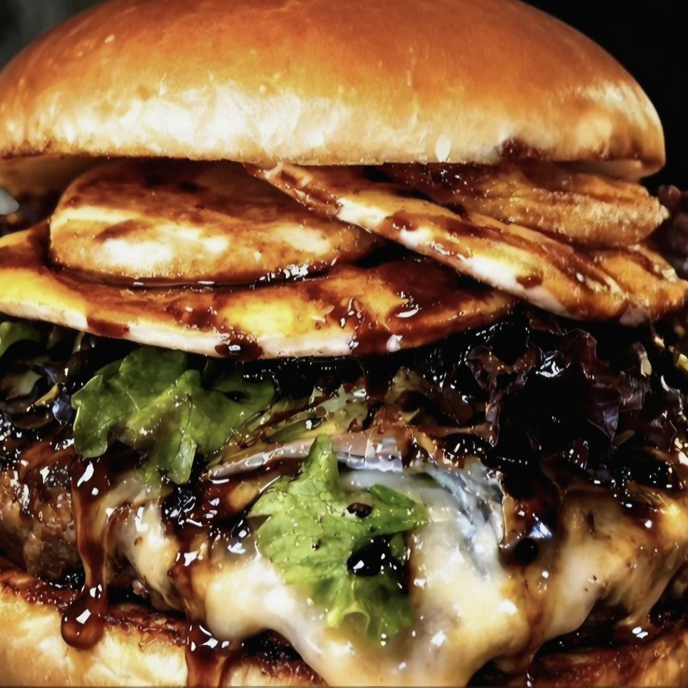 BTW burger with melted cheese and sauce on a brioche bun