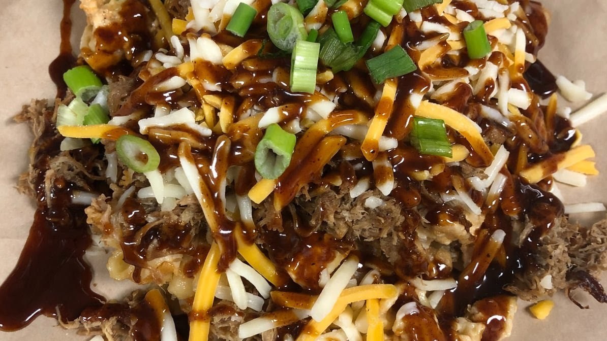 Cheeztopia: tater tot waffle with mac n' cheese, pulled pork, stout sriracha BBQ, and cheese